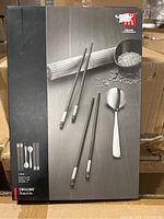 Front of the box showing the Zwilling chopstick set including two pairs of chopsticks and a small rice paddle image.