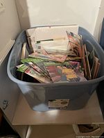 Box filled with a large collection of children's books with various colorful covers in good condition.