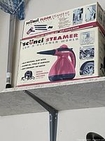 Photo of the Scunci floor steamer kit box showing product and accessory details