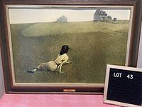 Framed print of Andrew Wyeth's "Christina's World" with label visible, showing overall artwork and frame condition.