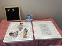 Photo showing the stained glass angel figurine and original foam packaging containing three collectible angel figurines and certificate.