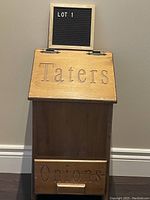 Front view showing the hinged lid labeled 'Taters' and drawer labeled 'Onions'