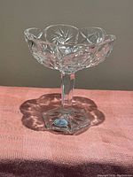Front view of the vintage Bohemian crystal stemmed candy dish showing clear pinwheel and diamond cut patterns, scalloped rim, and blue Bohemia Crystal sticker on the base.