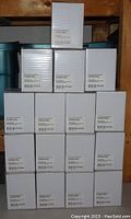 Full lot image showing 16 stacked white boxes of Nuprint toner cartridges labeled C546U1KG NUPC546B.
