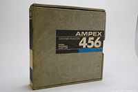 Closed gray cardboard box labeled AMPEX Grand Master 456 with black and blue text.