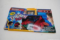 Wide edition Crayola Color Explosion 3-D coloring book package with markers and 3D glasses visible inside transparent blister pack.