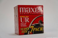 Front view of the red Maxell UR 7-pack audio cassette tape box highlighting the branding and 'Super Size 7 Pack' text.