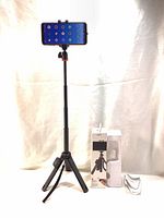 Photo of Joby TelePod tripod fully extended with smartphone mounted, retail box and packaging shown beside.