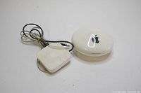 Photo showing both Apple AirPort Extreme base station and AirPort Express router together with visible Apple logo and wiring.