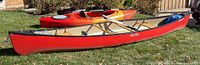 Red Old Town Penobscot canoe exterior with kayak behind