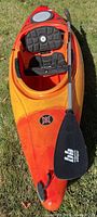 Full view of kayak with seat installed and paddle resting on hull