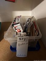 Plastic container holding multiple packs of batteries such as Energizer, Panasonic and loose batteries of various sizes.