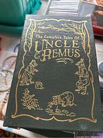 Close-up of 'The Complete Tales of Uncle Remus' hardcover book with decorative gold embossing
