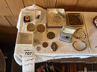 Overview of all jewelry and coins laid out on a white towel