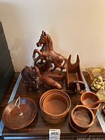 Photo showing all wooden animal figurines including a horse, elephant, and dog, alongside various wooden bowls and a cat-shaped holding stand.