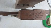 Close-up of wooden plane with stamp D. MALLOCH and D. MALLOCH & SON Perth showing maker's marks and condition