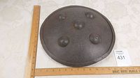 Top view of the round armored metal shield with rulers showing approximately 14 inches across diameter.