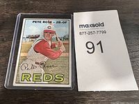 Front photo showing Pete Rose in batting stance in Cincinnati Reds uniform and printed signature.
