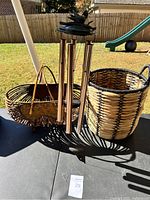 Full lot including two baskets and wind chime shown outdoors on a table.