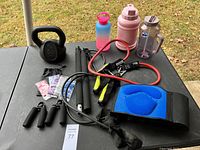 Overview of all fitness items including kettlebell, water bottles, resistance bands, jump rope, wrist grips, straps, and waist trimmer belt.