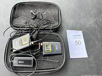 Photo showing wireless transmitter, receiver, and microphone within a foam-padded carrying case.