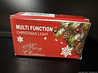 Box of Multi Function Christmas Light with holiday design and text on front