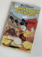 Cover of Walt Disney's Donald Duck Adventures comic No. 25, showing Donald in a historical outfit with a bull, titled 'Dangerous Disguise!'