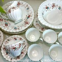 Photo shows multiple Johnson Brothers dishes including plates, bowls, cups, and saucers with red and blue floral pattern on white ironstone with scalloped edges.