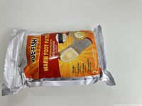 Packaged JUE-FISH Warm Foot Patch sealed in silver pouch showing product label and quantity