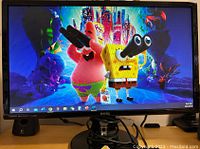 Front view of BenQ monitor powered on, displaying vibrant animated image of SpongeBob SquarePants characters.