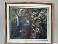 Frontal view of large gold-colored framed abstract foliage print with decorative mat
