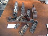 Top view of all eight hand planes showing Stanley Bailey #5 and two Stanley 220 block planes plus others.