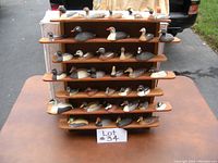 Full front view of wooden rack populated with all 36 duck decoys