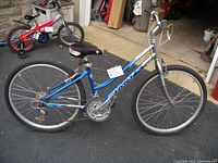 Side profile of the blue and silver Giant Sedona mountain bike showing frame, tires, seat and handle bars.