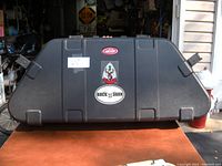 Full view of the black SKB bow case with stickers and visible latches.