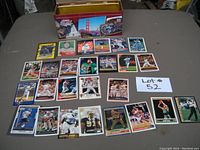 Overview of sports trading cards spread on a table with the metal tin behind