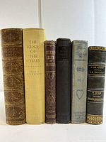 Front view of six vintage classic hardbound books, showing spine titles and condition details