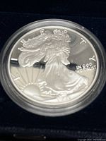 Close-up of obverse side of the silver proof coin showing Lady Liberty with flowing drapery and rising sun.