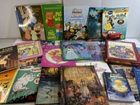 Photo showing multiple children's books including Disney titles, Richard Scarry's Pig Will and Pig Won't, Halloween themed book, and Dr. Seuss's Horton Hatches the Egg.