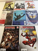 Top view of 8 Deadpool Merc with a Mouth comics laid out on a surface, showcasing cover art and condition.