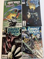 Photo of 4 Ghost Rider 2099 comic books, all in protective sleeves, showing different covers with characters and dynamic scenes.