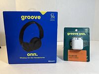 Blue box of ONN Groove Wireless On-Ear Headphones showing front with product image and playtime.