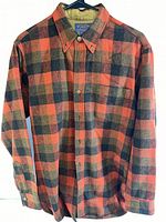 Front view of Pendleton men's shirt in orange black grey plaid, showing button-up front and button-down collar.