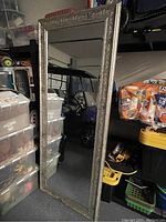 Full view of the six-foot standing mirror showing the entire frame and reflective surface.