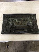 Full view of the antique copper plaque showing the entire Last Supper scene with figures around the table and detailed ceiling.