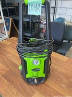 Front view of Greenworks pressure washer showing power dial and cord wrapped around handle.
