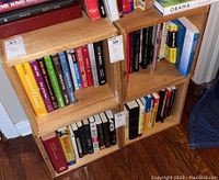 Four wooden crates stacked and filled with books (books not included in sale) on a wood floor.