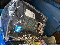 Packaged king size comforter set in clear zippered bag showing label and scroll pattern design.