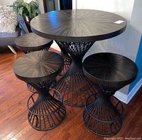 Table and four matching stools from side angle showing overall design and surface finish