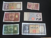 Six Italian paper money notes arranged on black surface, showing various denominations and worn conditions.